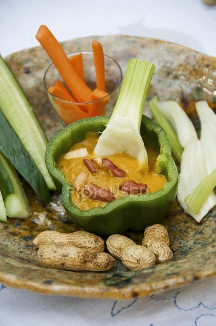 Aubergine and pepper dip with crudites on plate over white surface — Stock Photo