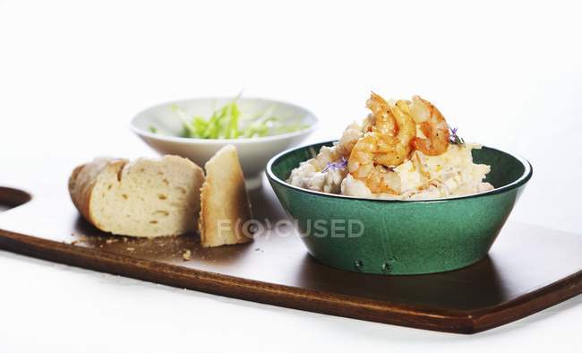Potato mayonnaise salad with prawns on chopping desk on white background — Stock Photo