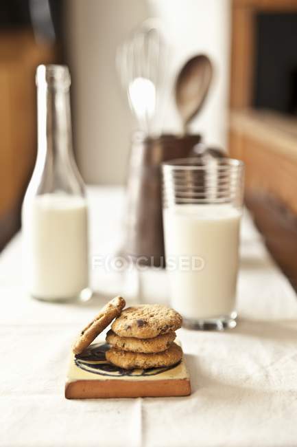 Chocolate chip cookies on wooden board — Stock Photo