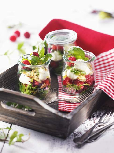 Jars of raspberries with mozzarella — Stock Photo