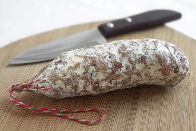French salami on wooden board — Stock Photo