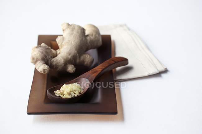 Grated ginger on wooden spoon — Stock Photo