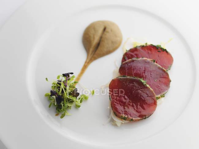 Slices of tuna with mustard and cress — Stock Photo