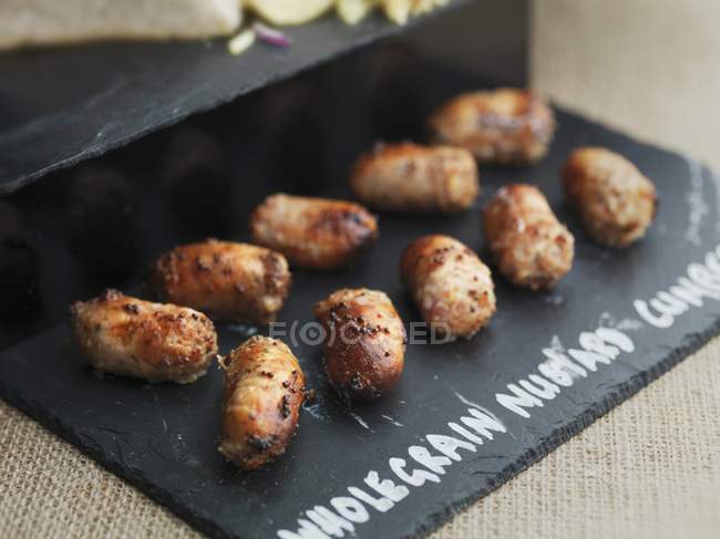 Wholegrain mustard sausages — Stock Photo