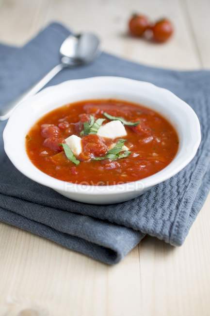Tomato soup with mozzarella and basil — Stock Photo