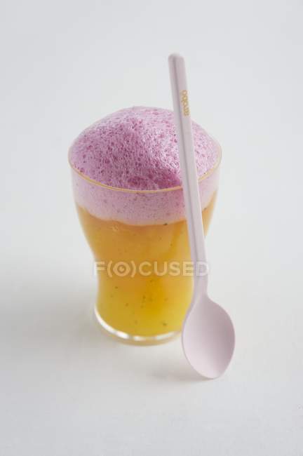 Closeup view of orange puree with strawberry foam — Stock Photo
