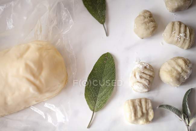 Top view of fresh Gnocchi, butter and sage leaves — Stock Photo