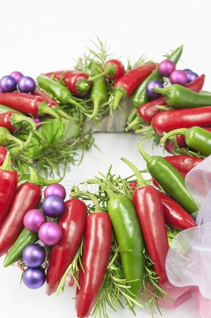 Advent wreath with red and green chili peppers — Stock Photo