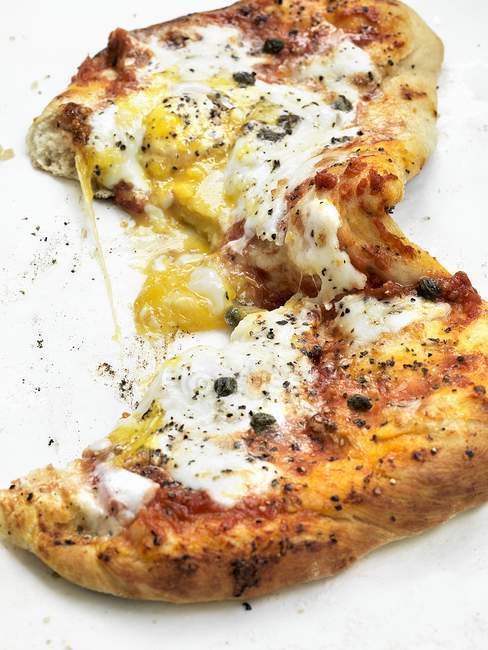 Pizza topped with egg and capers — Stock Photo