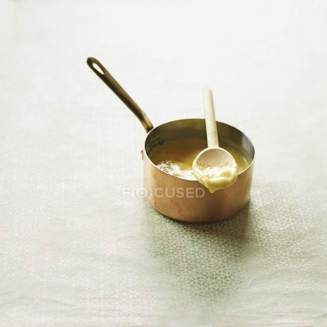 Closeup view of vanilla cream in a saucepan with a spoon — Stock Photo
