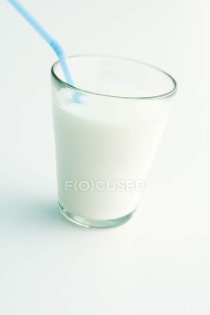 Glass of milk with a straw — Stock Photo