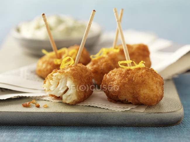 Fried cod cheeks with lemon zest — Stock Photo
