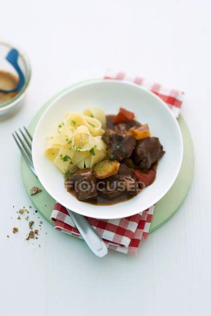 Goulash meat with tagliatelle pasta — Stock Photo