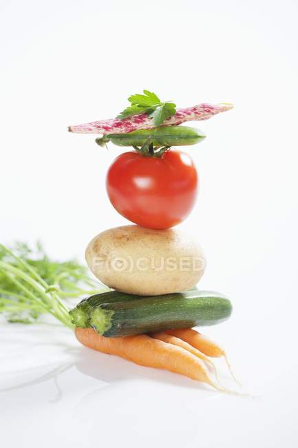 Stack of vegetables on white background — Stock Photo