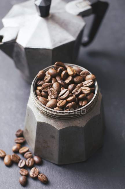 Coffee beans in espresso maker — Stock Photo