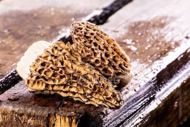 Fresh morel mushrooms on a wooden crate — Stock Photo