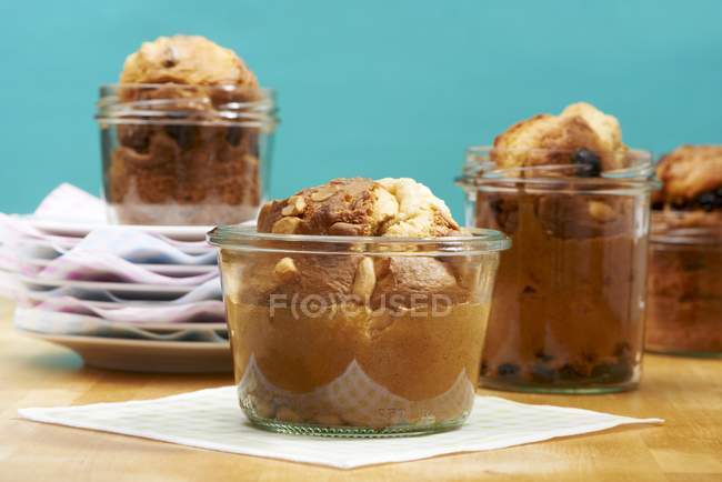 Large peanut muffins in glass jars — Stock Photo