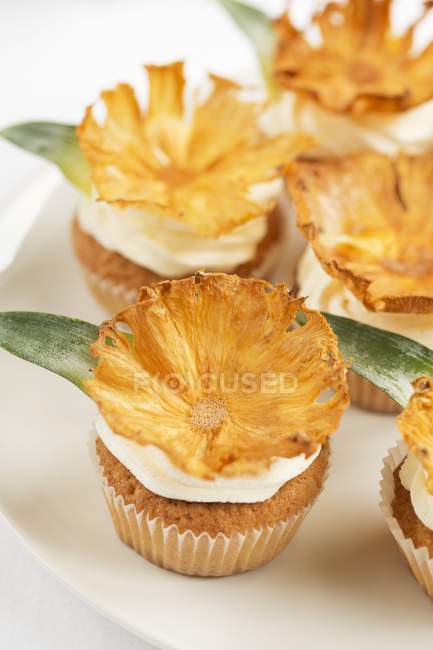 Cupcakes decorated with pineapple chips — Stock Photo