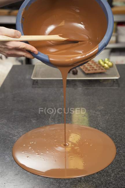 Hand pouring Melted chocolate — Stock Photo
