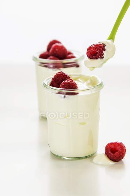 Closeup view of white chocolate cream with raspberries — Stock Photo
