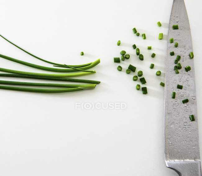 Fresh Chopped chives and knife — Stock Photo
