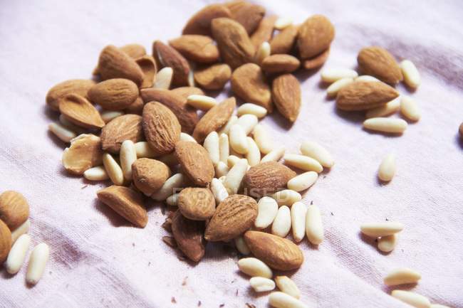 Heap of Almonds and pine nuts — Stock Photo