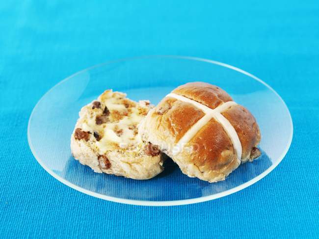 Halved hot cross bun with butter — Stock Photo
