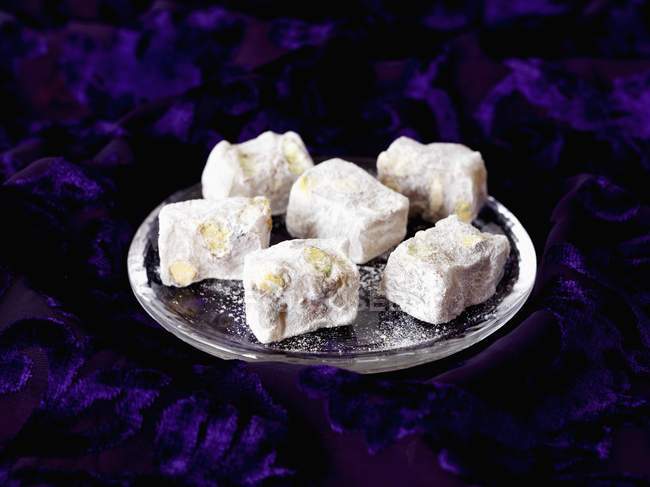 Closeup view of Turkish Delight with pistachios on metal plate — Stock Photo