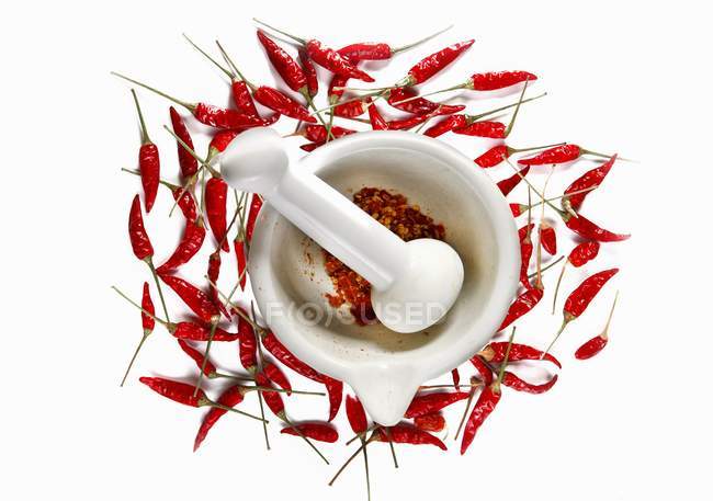 Crushed chilli peppers in mortar — Stock Photo