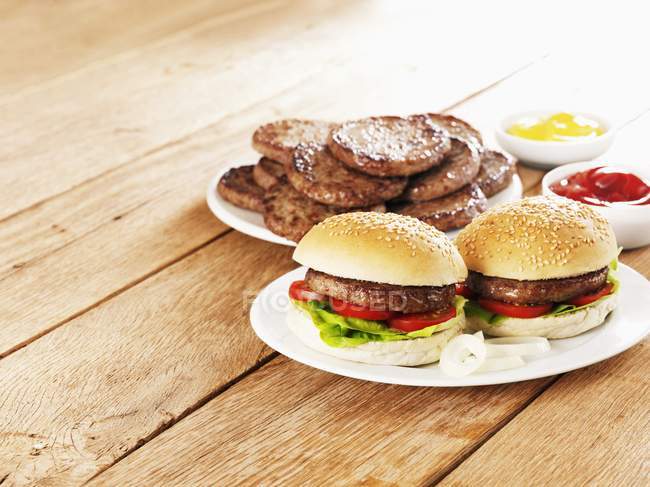 Beefburgers with mustard and ketchup — Stock Photo