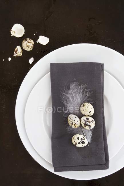 A place setting with a grey napkin decorated with quail eggs — Stock Photo