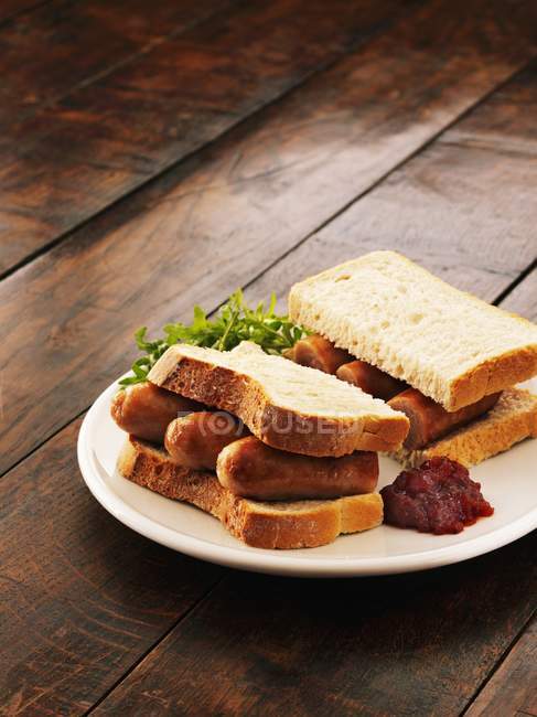 Sausage sandwich with salsa — Stock Photo