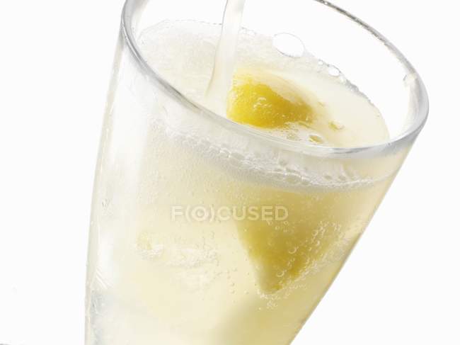 Glass of fizzing lemonade — Stock Photo