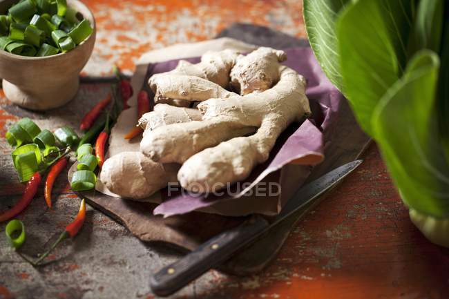 Root ginger with chilli peppers — Stock Photo