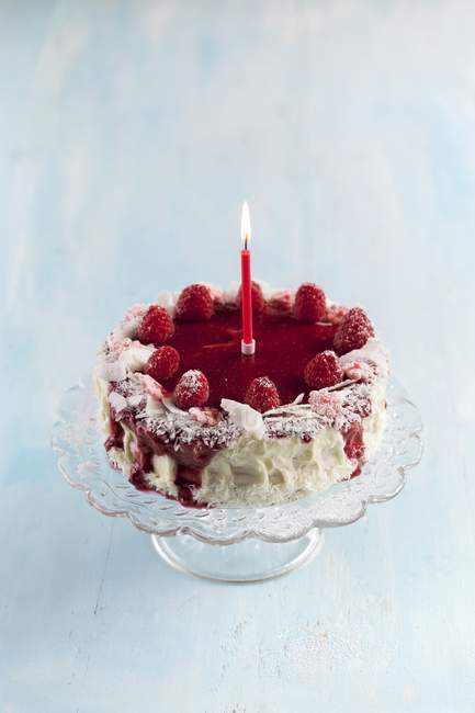 Raspberry cake with candle — Stock Photo