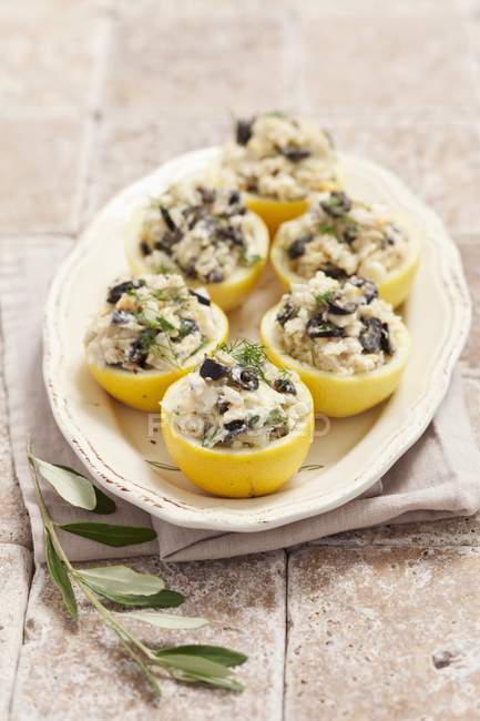 Lemons stuffed with cod and olives — Stock Photo
