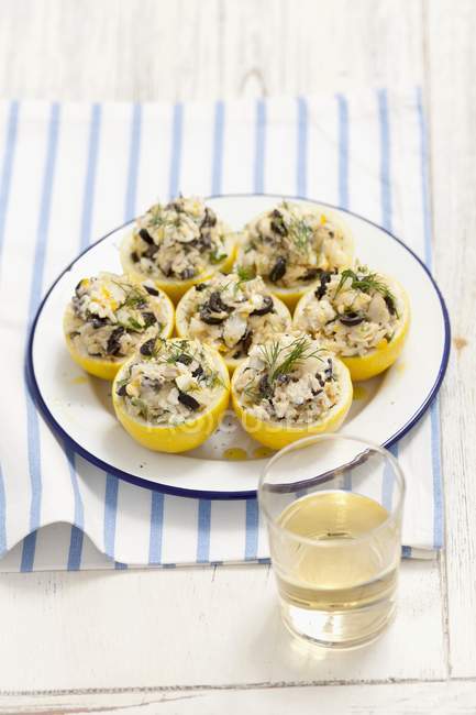 Lemons filled with cod and olives — Stock Photo