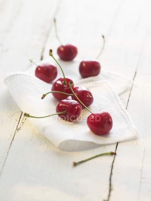 Fresh Cherries on white cloth — Stock Photo