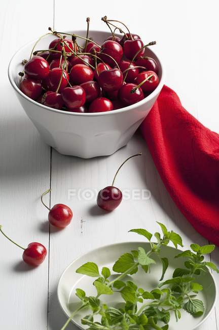 Fresh cherries in white bowl — Stock Photo