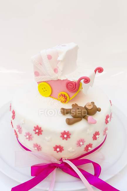 Cake decorated with pram and teddy bear — Stock Photo
