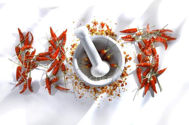 Red chili peppers with a mortar — Stock Photo