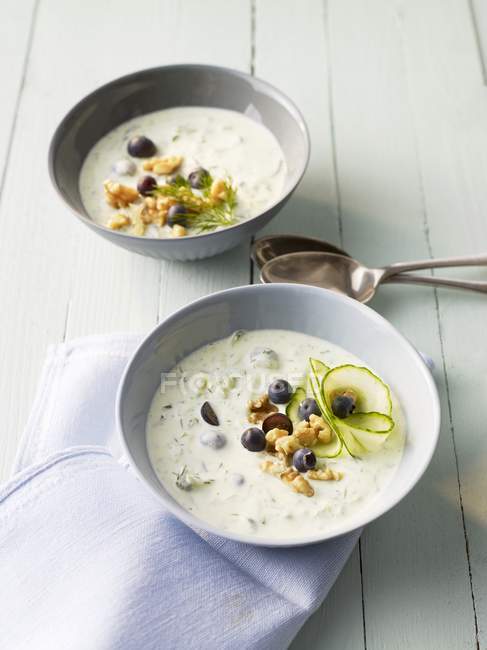 Cold cucumber soup with blueberries and nuts — Stock Photo