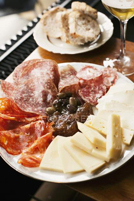 Antipasti platter featuring salami — Stock Photo