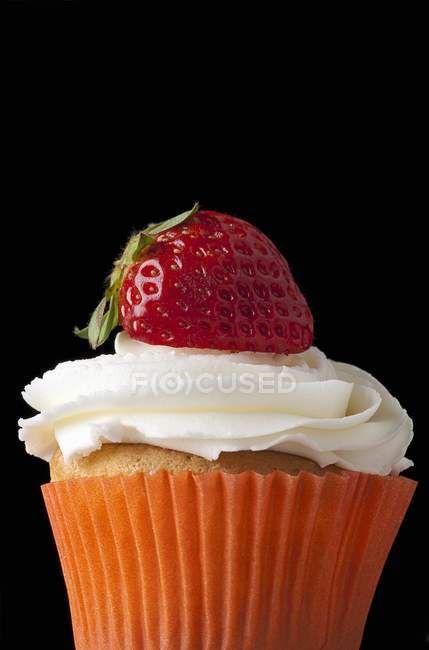 Cupcake topped with cream — Stock Photo