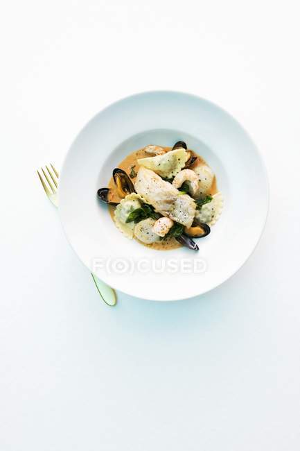 Fish soup with ravioli pasta — Stock Photo