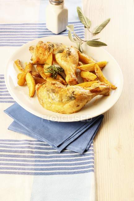 Chicken legs with sage and fries — Stock Photo