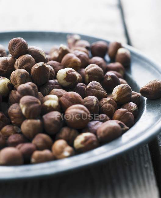 Hazelnuts on metal plate — Stock Photo