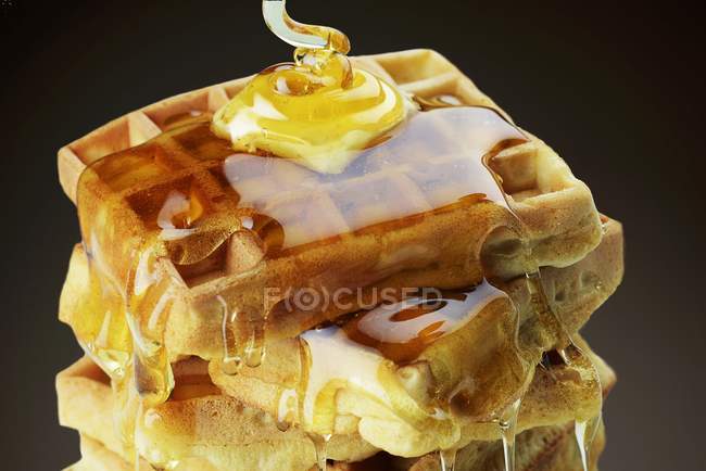 Stack of waffles with honey — Stock Photo