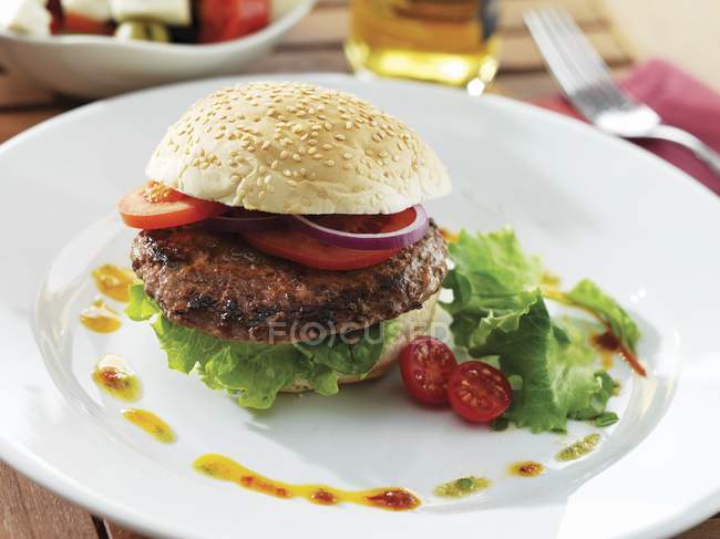 Bison burger with vegetables and greens — Stock Photo