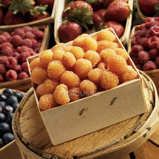 Yellow raspberries in wooden box — Stock Photo